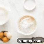 dry ingredients for a cake in a white bowl.