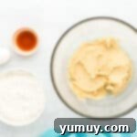 Tropical Coconut Chocolate Chip Delight 6 creamed wet ingredients for coconut chocolate chip cookies in a glass bowl.