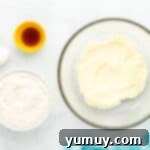 Creamed butter and sugar in a glass bowl, ready for the next steps.