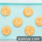 6 baked orange creamsicle cookies on a blue baking sheet.