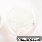 Effortless Red Velvet Cake from a Mix 13 crumb coated red velvet cake on a white cake stand.