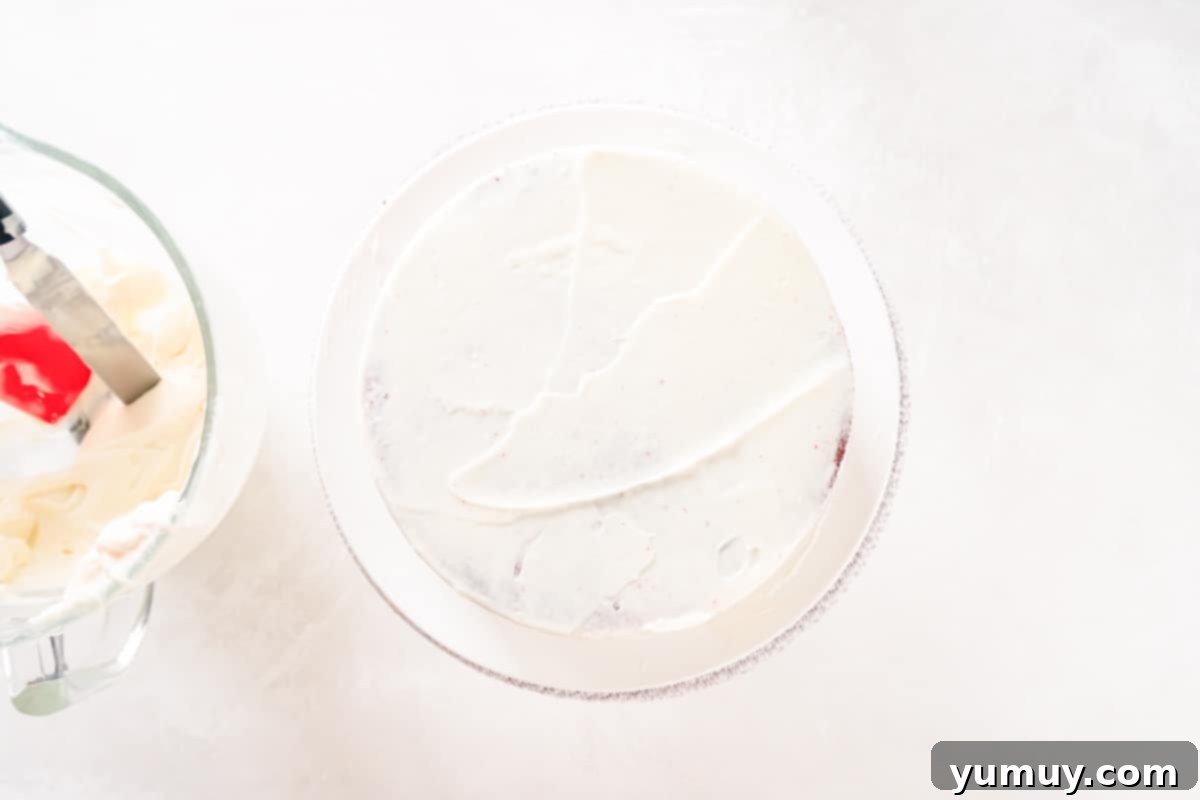 Effortless Red Velvet Cake from a Mix 23 crumb coated red velvet cake on a white cake stand.