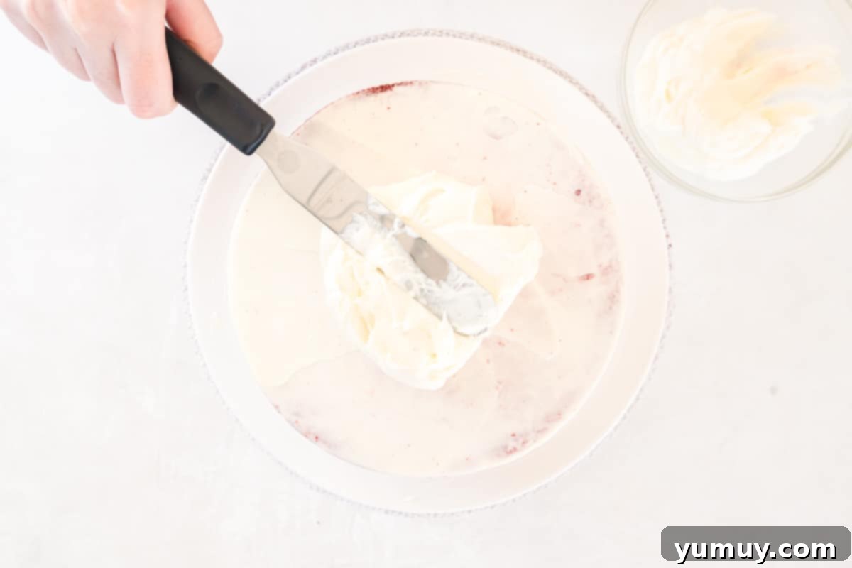 Effortless Red Velvet Cake from a Mix 24 frosting spread over red velvet cake.