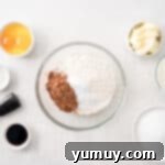 Effortless Red Velvet Cake from a Mix 5 dry ingredients for red velvet cake in a glass bowl.