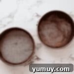 Two round cake pans greased and dusted with cocoa powder.