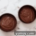 Devil's food cake batter divided between two cake pans.