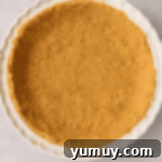 Sunshine Slice 5 graham cracker crust pressed into a ceramic pie dish.