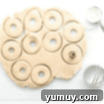 cutting out doughnuts from dough.