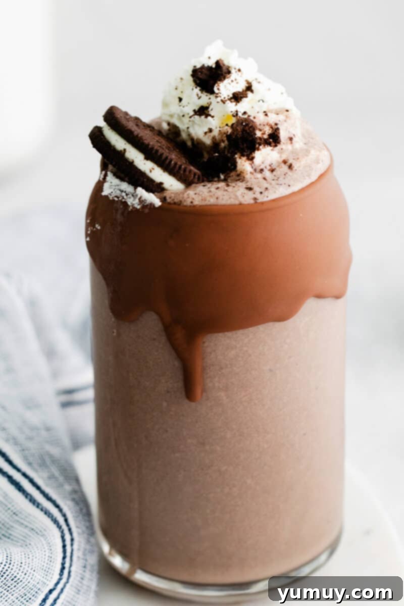 Creamy Oreo Dream 3 A close-up of a frosted glass filled with a creamy Oreo milkshake, ready to be enjoyed.
