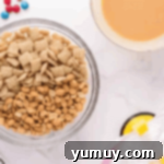 chex and peanuts in a glass bowl.