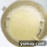 foamy eggs in a stainless steel bowl.