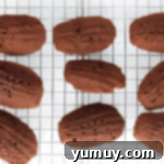 baked chocolate madeleines on a wire rack.