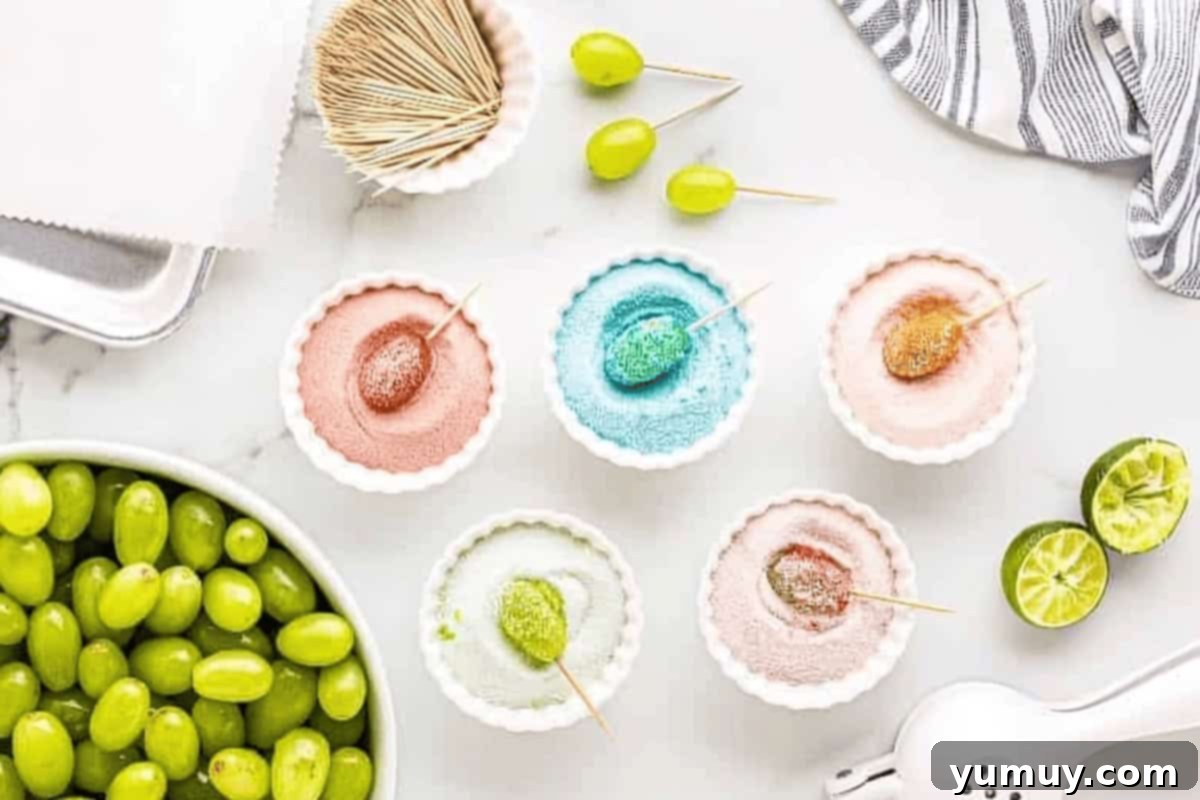 a single grape in each of 5 different colors/flavors of jello powder.