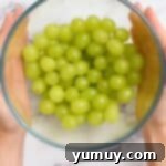A bowl of green grapes that have been de-stemmed and washed.