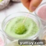 Coating a grape in powdered gelatin.