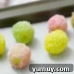 Jello-coated grapes on parchment paper.