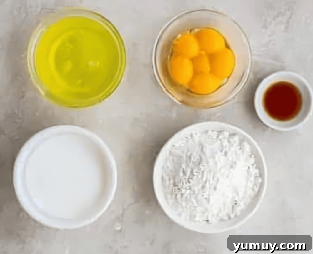 Pan di Spagna 12 All the necessary ingredients for Italian sponge cake, including separated eggs, laid out on a kitchen counter.