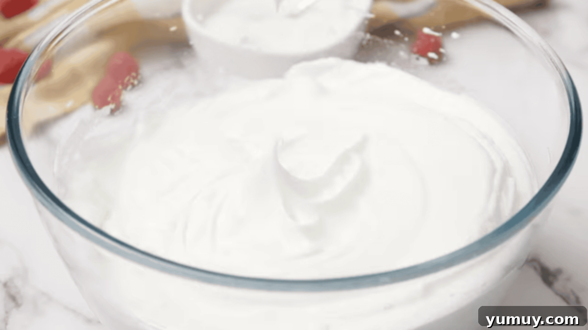 Pan di Spagna 13 Lustrous, stiffly whipped egg whites in a clean glass bowl, ready for the next step.