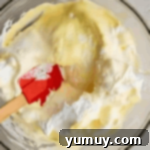 Pan di Spagna 8 Carefully folding egg yolk mixture into whipped egg whites.