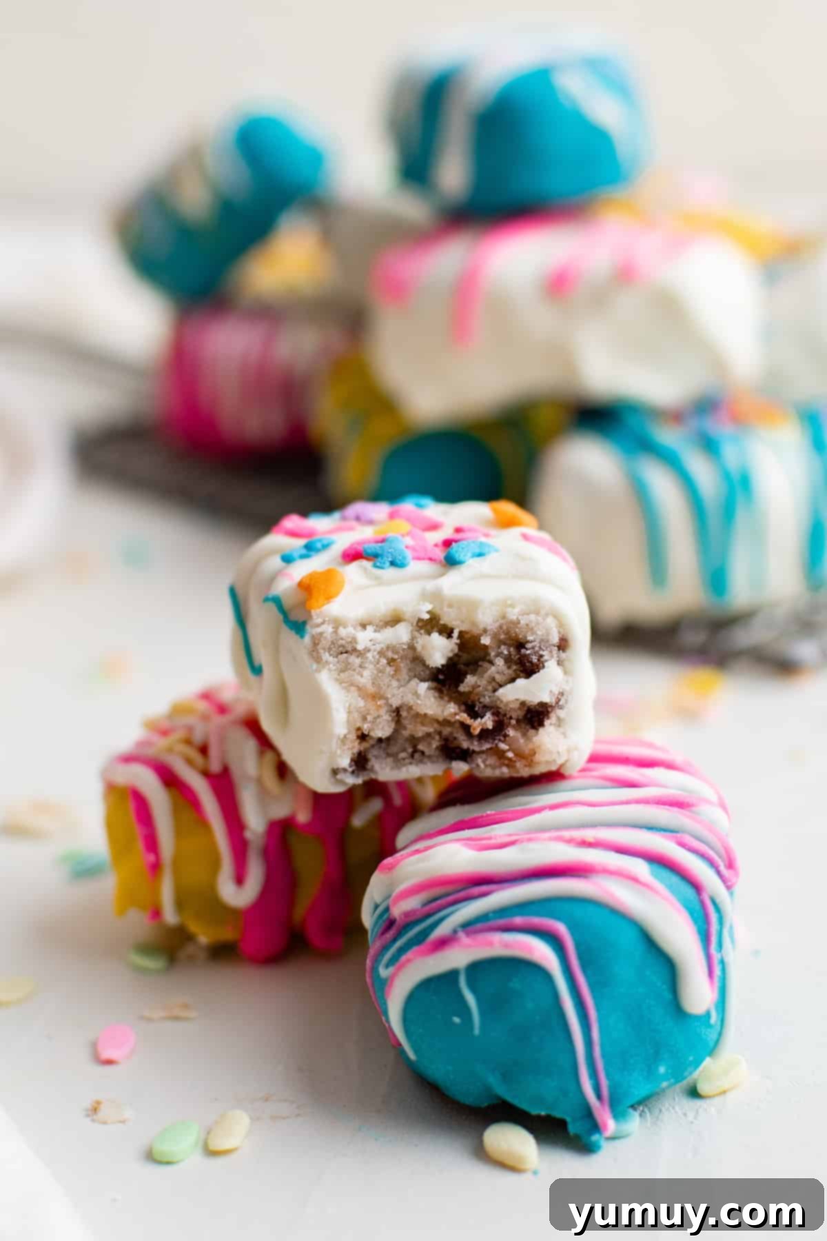Close-up of chocolate covered Easter cookie dough truffles, showing vibrant colors and sprinkles.