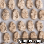 egg-shaped cookie dough on a baking sheet.