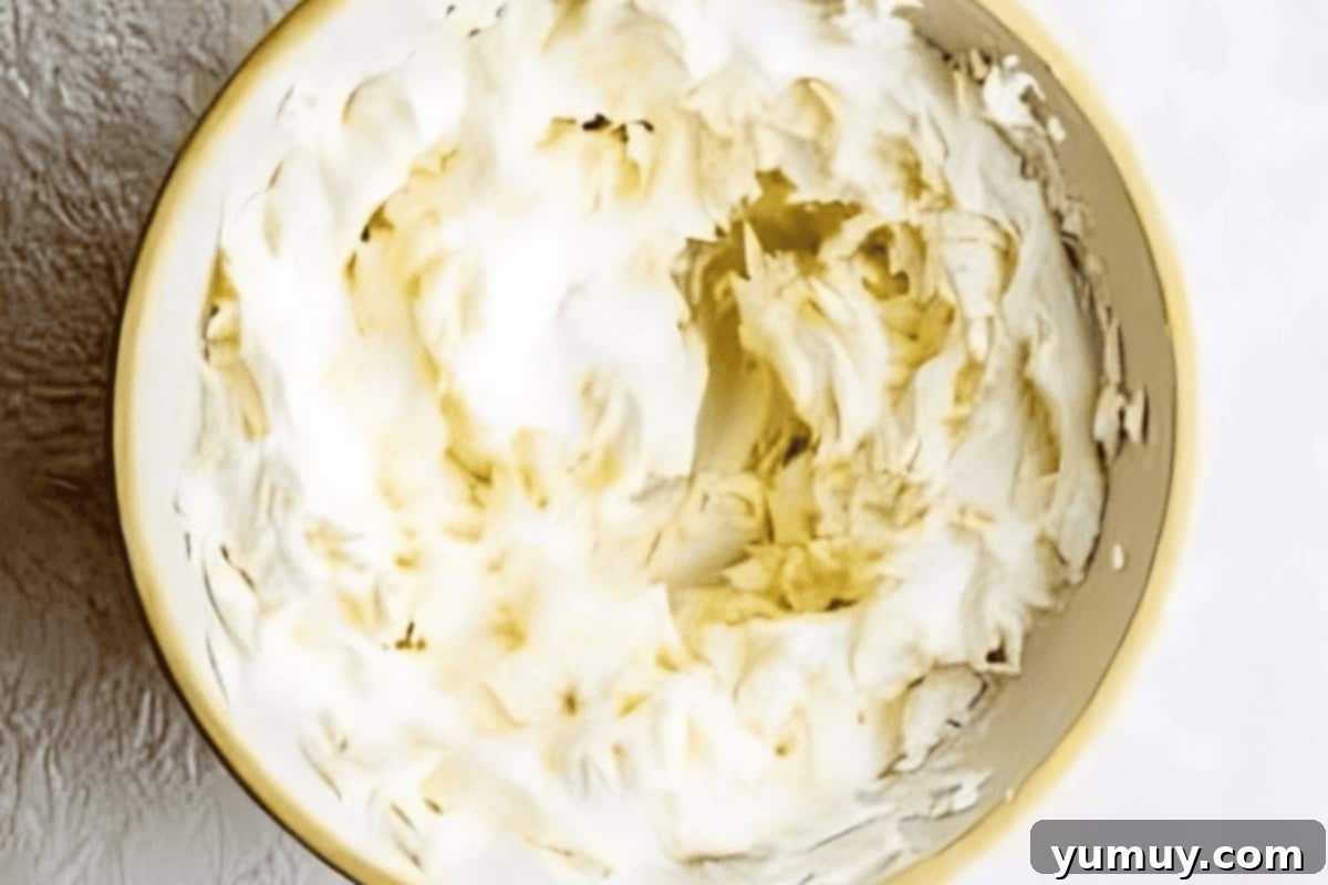 Luscious Vanilla Sheet Cake 14 fluffy vanilla frosting in a white bowl.