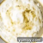 Luscious Vanilla Sheet Cake 8 fluffy vanilla frosting in a white bowl.