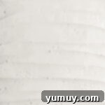 Luscious Vanilla Sheet Cake 9 vanilla frosting spread over vanilla sheet cake in a cake pan.