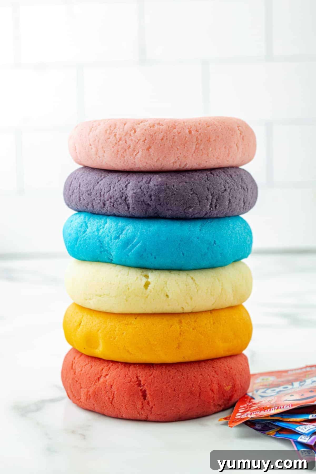 Fun Fragrant Kool Aid Playdough 2 Stacked colors of homemade Kool-Aid playdough, showcasing its vibrant hues and smooth texture, perfect for sensory play and creative fun.