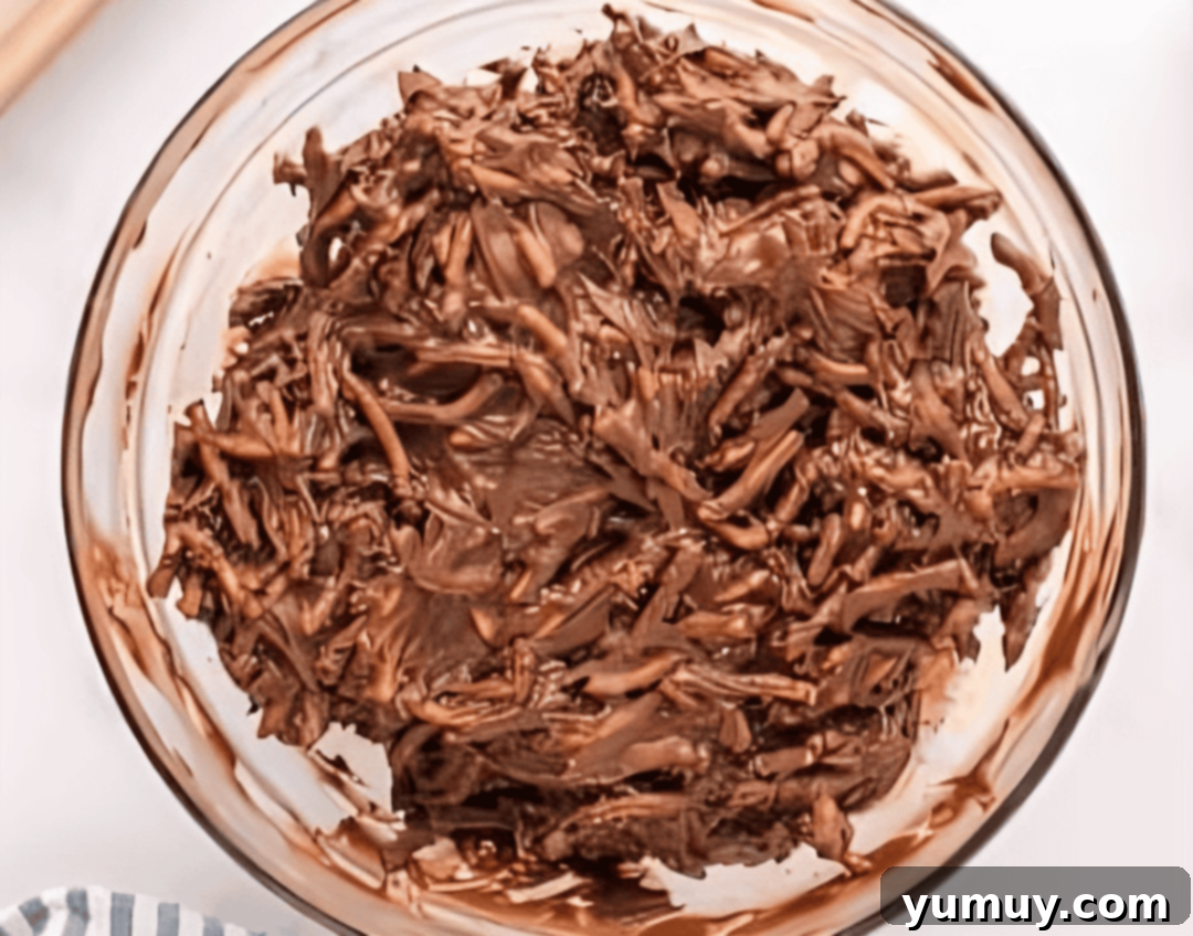 chocolate-coated chow mein noodles in a glass bowl.
