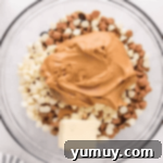 chocolate, butterscotch, and white chocolate chops in a glass bowl with peanut butter and butter.