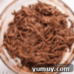 chocolate-coated chow mein noodles in a glass bowl.