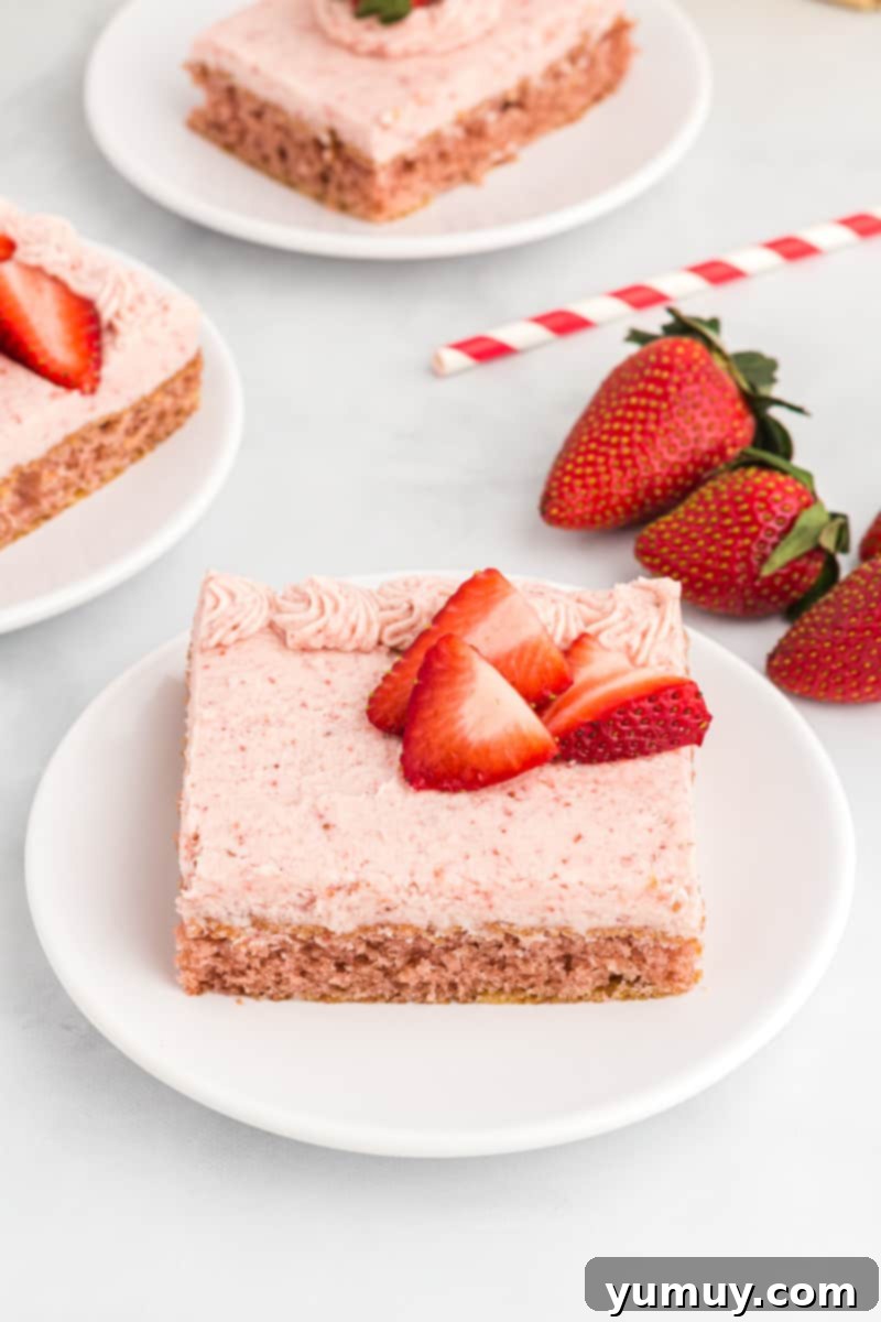 strawberry sheet cake slices on white plates.