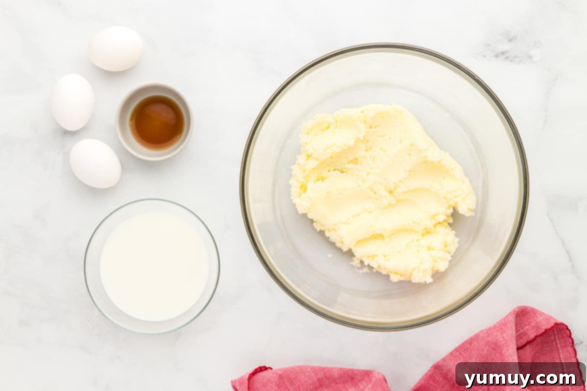 bowls of creamed butter, cream, and vanilla.