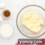 a bowl of butter and eggs on a marble table.