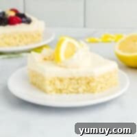Sunshine Lemon Sheet Cake 4 a slice of lemon cake on a white plate, perfectly frosted and ready to eat.