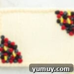 Sunshine Lemon Sheet Cake 9 a decorated lemon sheet cake with fresh berries and lemon slices on a white plate, showcasing its vibrant appeal.