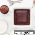 a white baking dish with a chocolate cake in it.