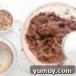 a person mixing ingredients in a bowl.