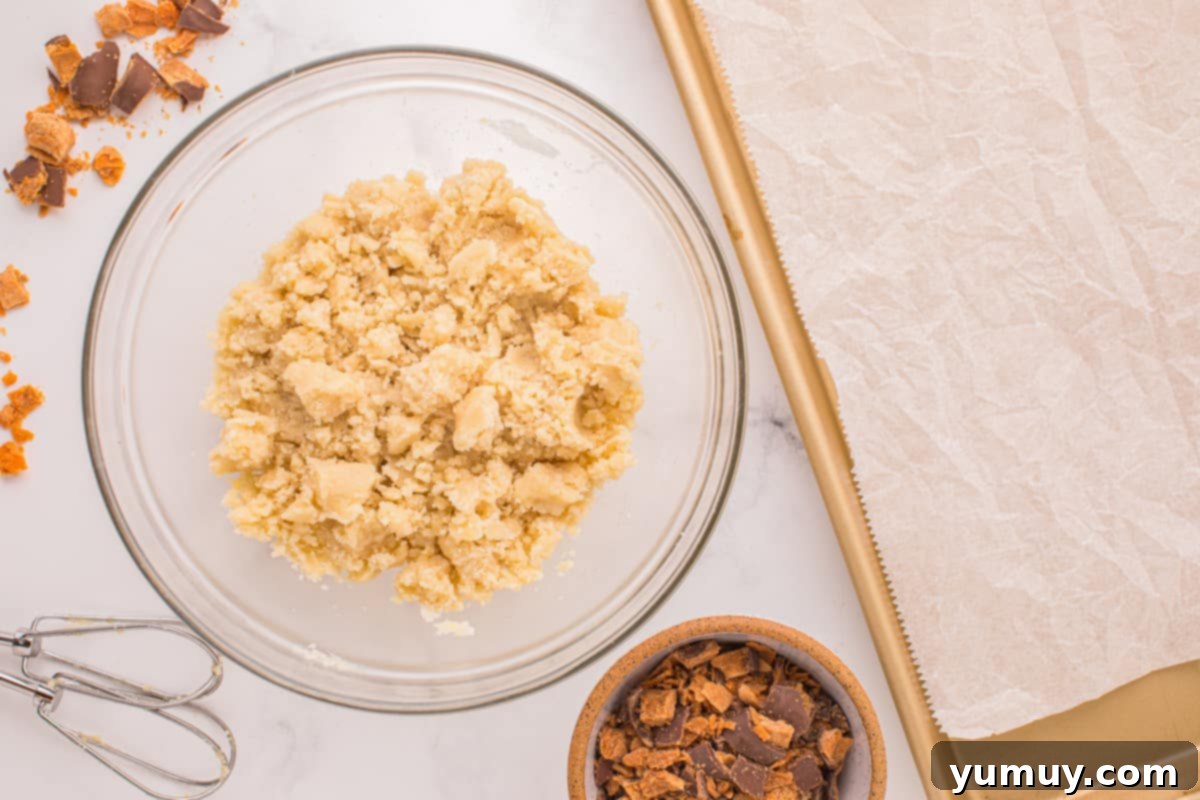 A mixing bowl filled with smooth cookie dough, demonstrating the perfect consistency after combining ingredients.