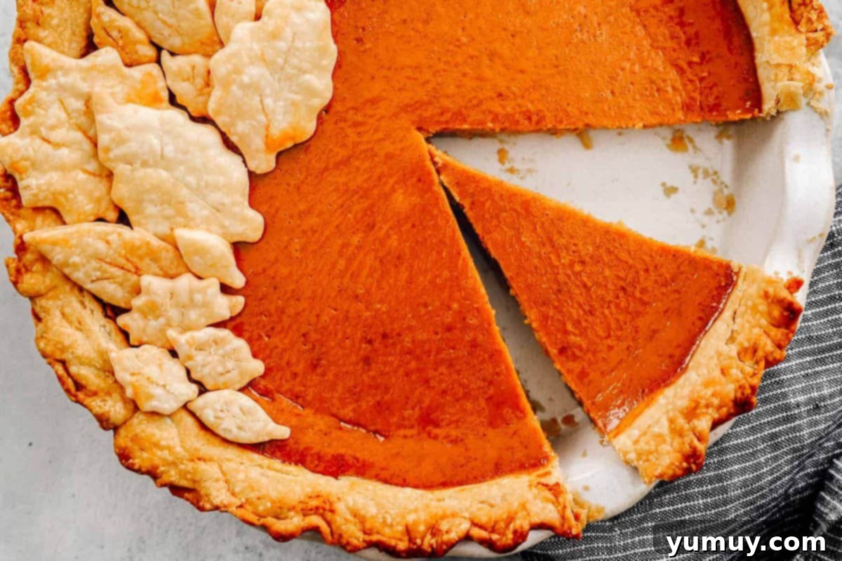 Effortless Pumpkin Puree Delights 3 overhead image of pumpkin pie with a slice removed