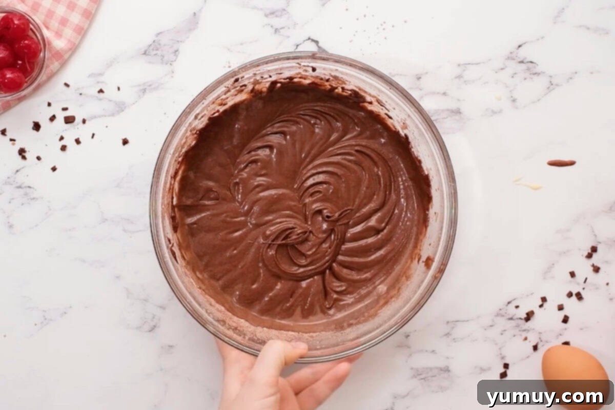 chocolate cupcake batter in a glass bowl.