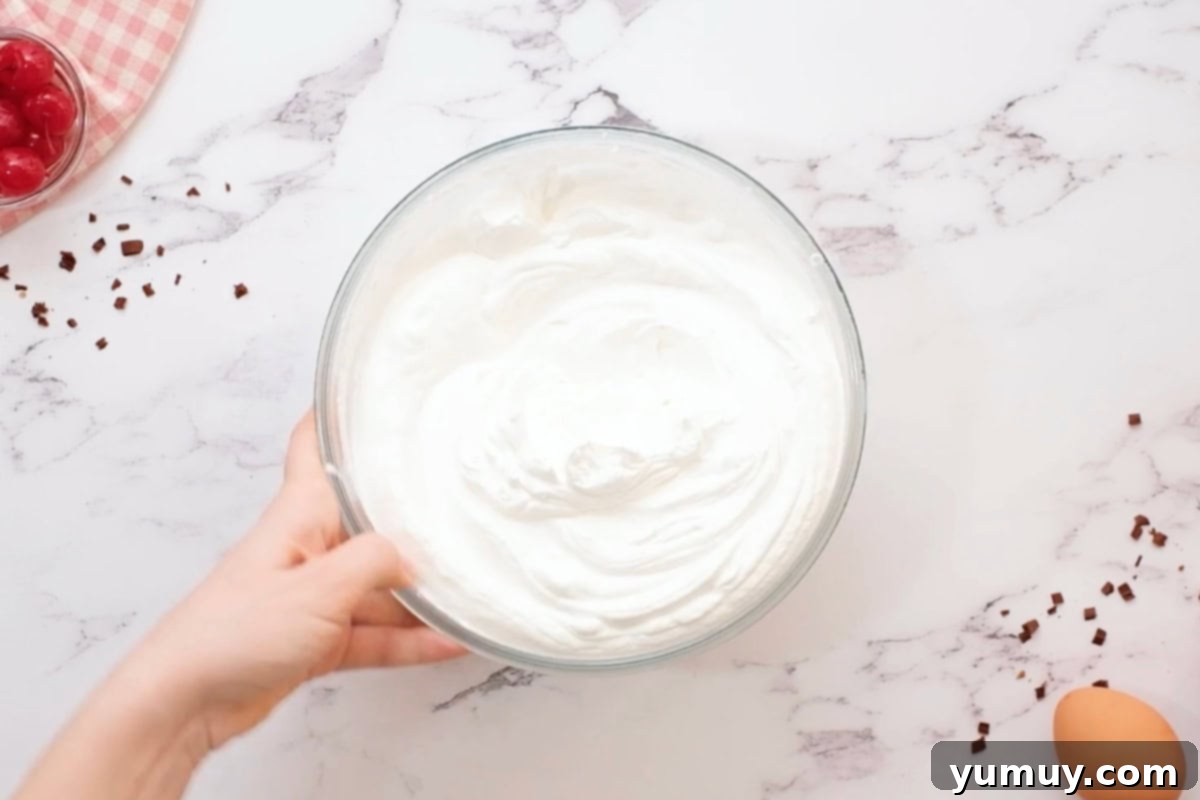 stabilized whipped cream frosting in a glass bowl.