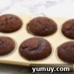 baked chocolate cupcakes in a cupcake tin.