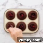 filling chocolate cupcakes with cherry pie filling.
