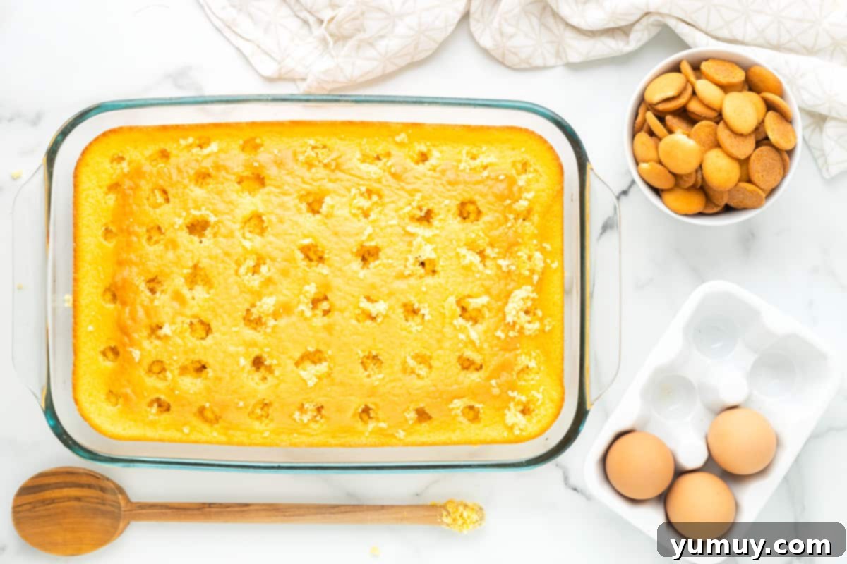 yellow cake with holes poked in it