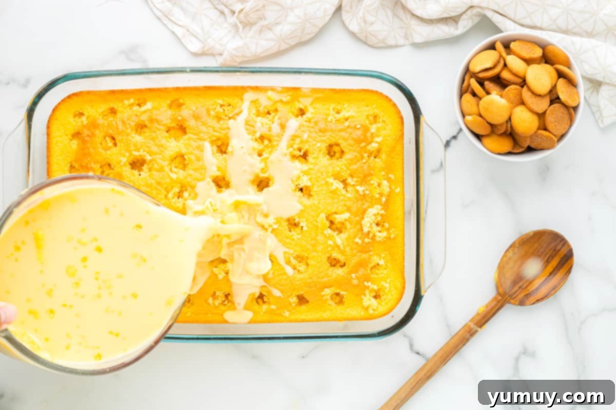 pouring pudding mixture on top of cake in a glass baking dish