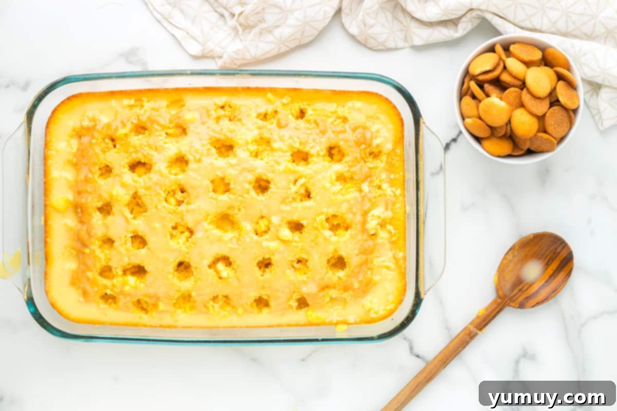 pudding mixture on top of baked cake in a glass baking dish