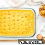 yellow cake with holes poked in it