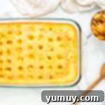 pudding mixture on top of baked cake in a glass baking dish